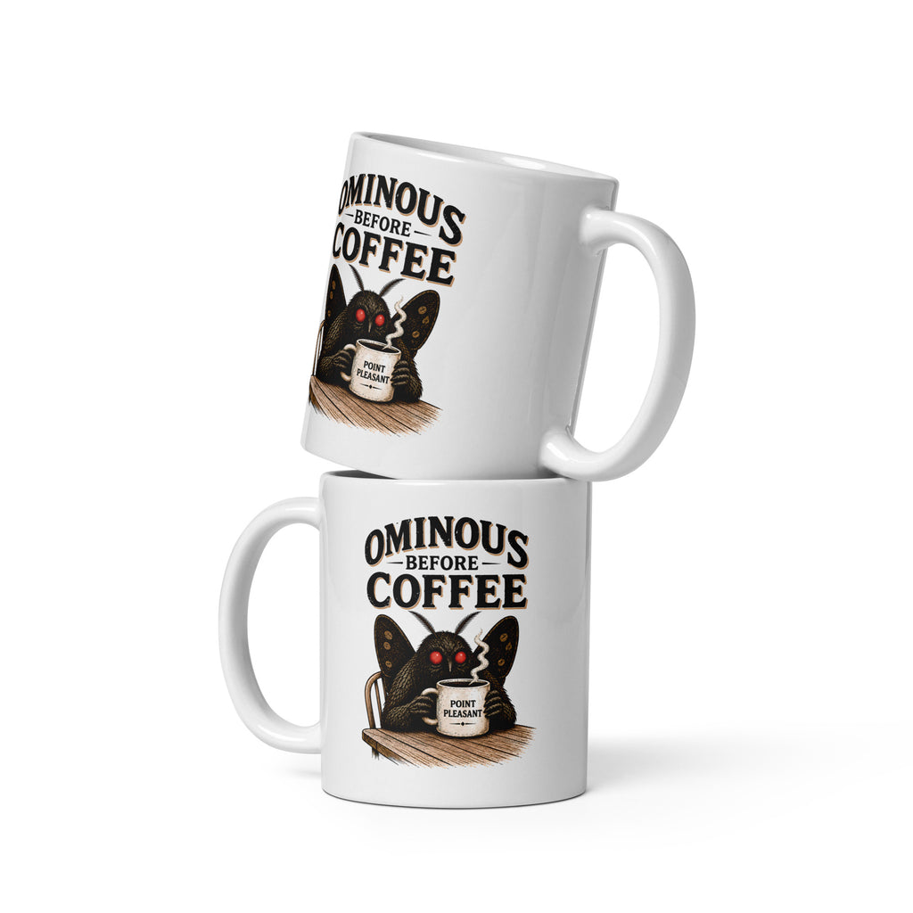 Vintage Mothman coffee mug featuring glowing red eyes and “Ominous Before Coffee” artwork. A funny cryptid gift for coffee lovers and folklore fans.