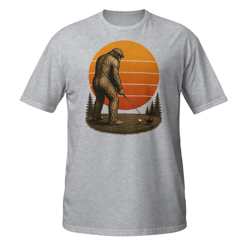 Vintage Bigfoot golfing graphic tee featuring Sasquatch lining up his drive beneath a retro sunset. A funny cryptid shirt for golfers and Bigfoot fans.